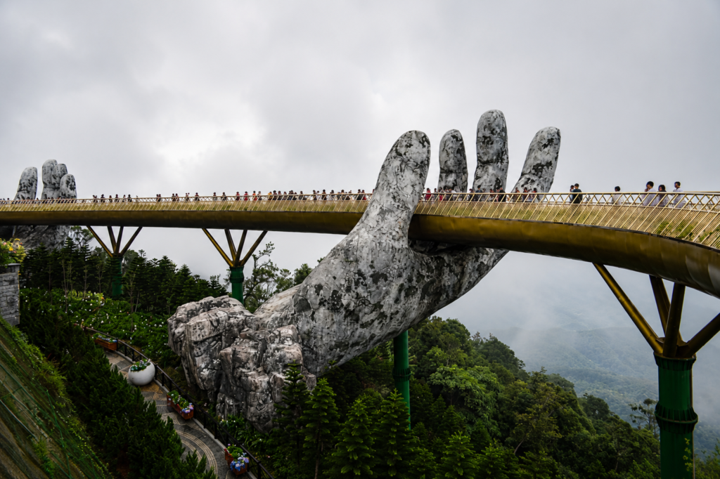 Stunning view of the Golden Bridge supported by giant stone hands in Vietnam, shrouded in mist.