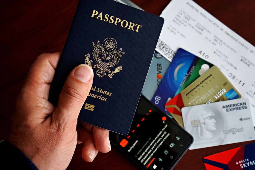 US passport with credit cards and travel documents on a table