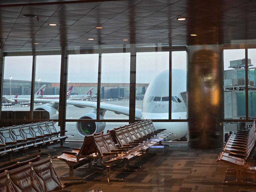 A passenger plane at International Airport with empty seating area in the foreground.