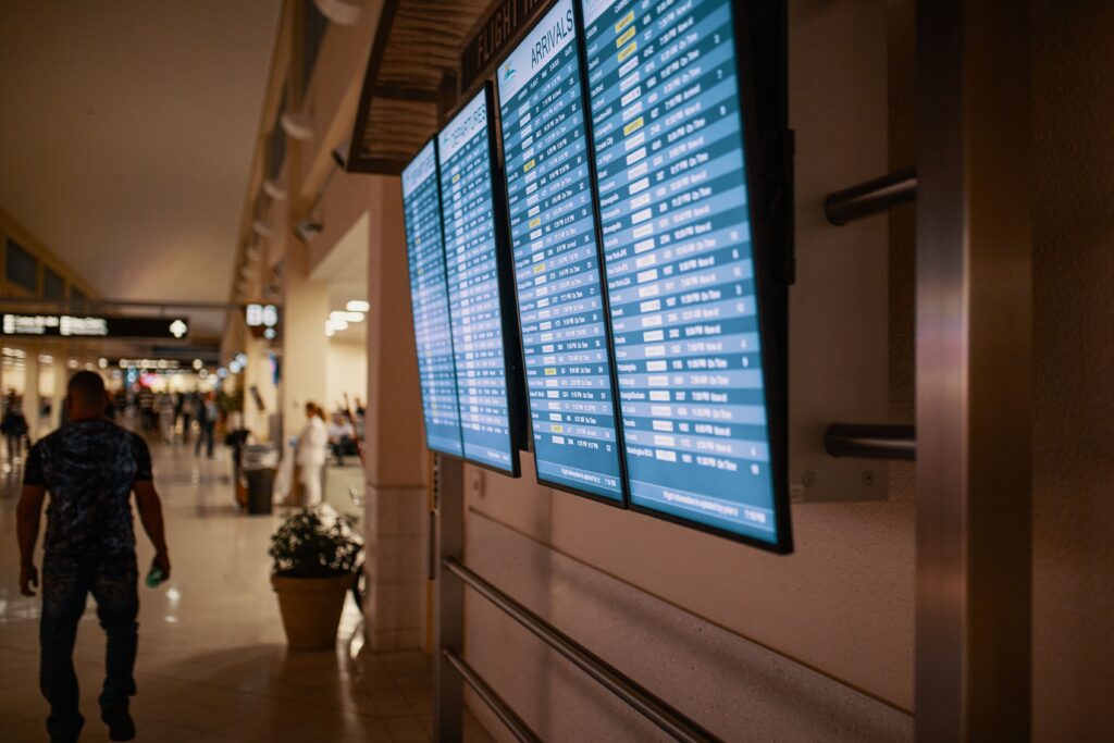 airport terminal departures board with flight listings