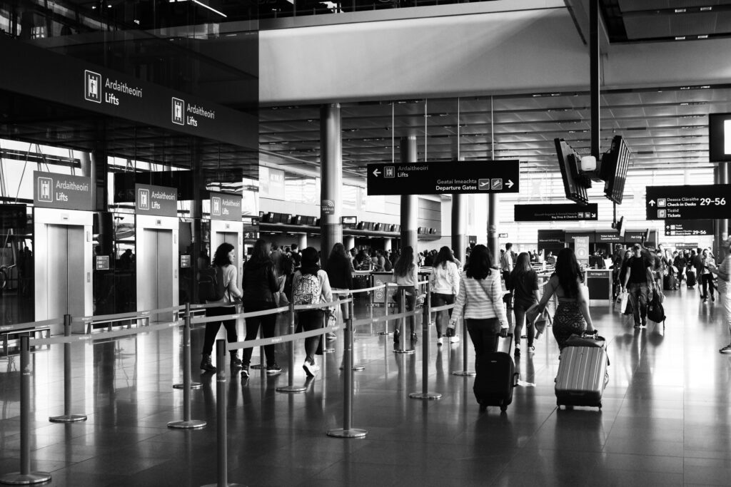 airline staff scanning boarding pass at departure gate 2026