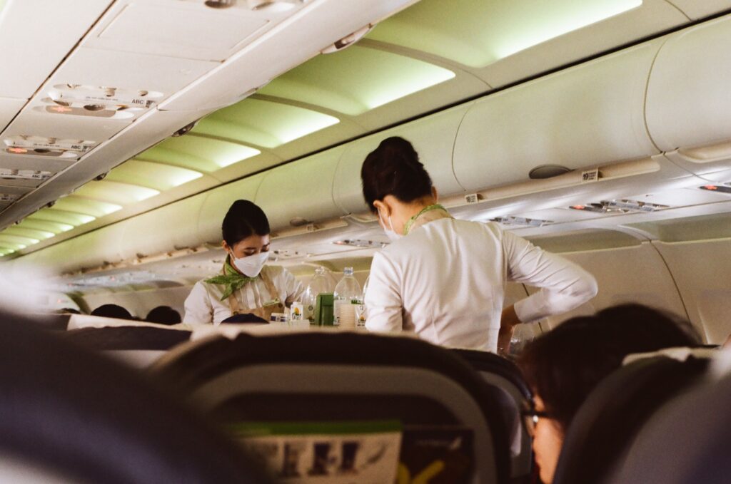 Flight attendant preparing cabin before departure