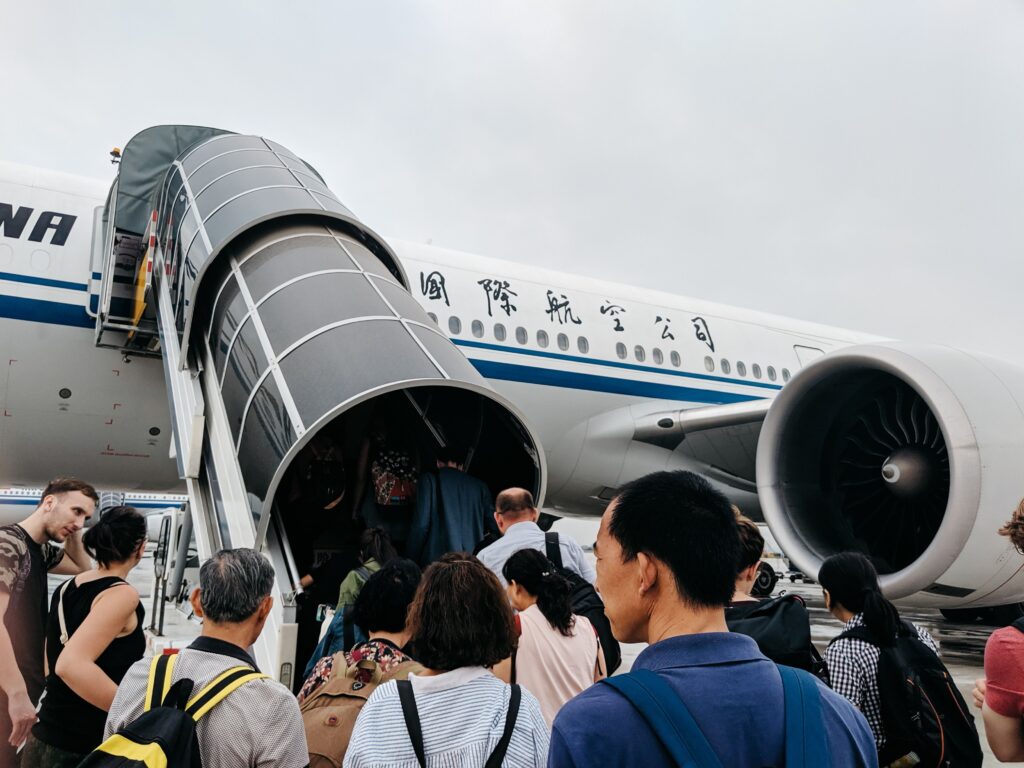 Passengers walking down a jet bridge to board a flight from a US airport