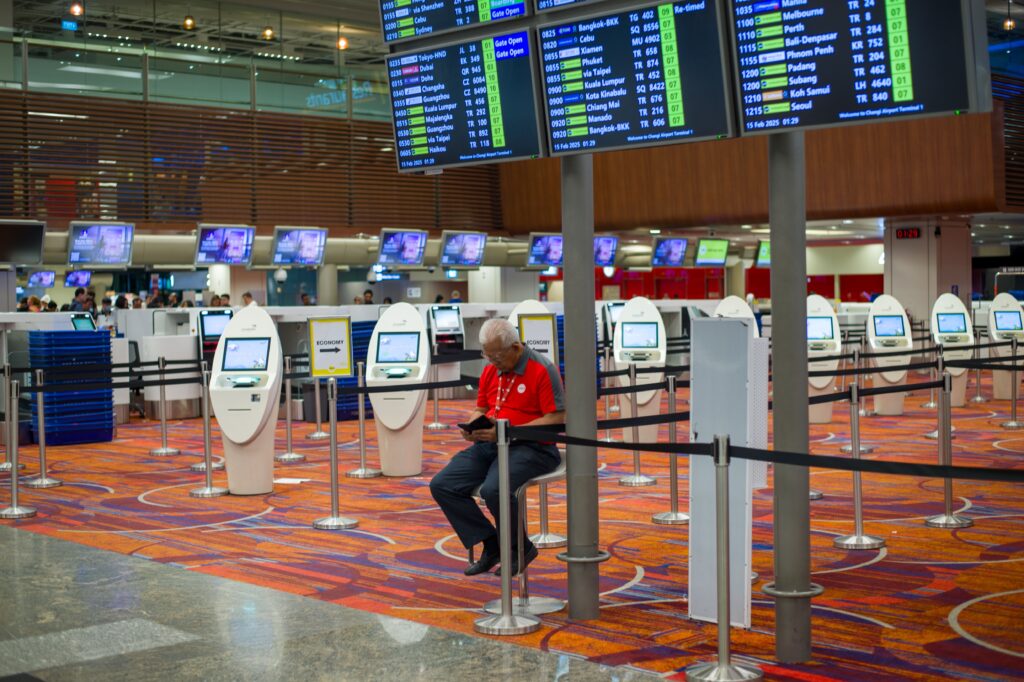 airline staff scanning boarding pass at departure gate 2026